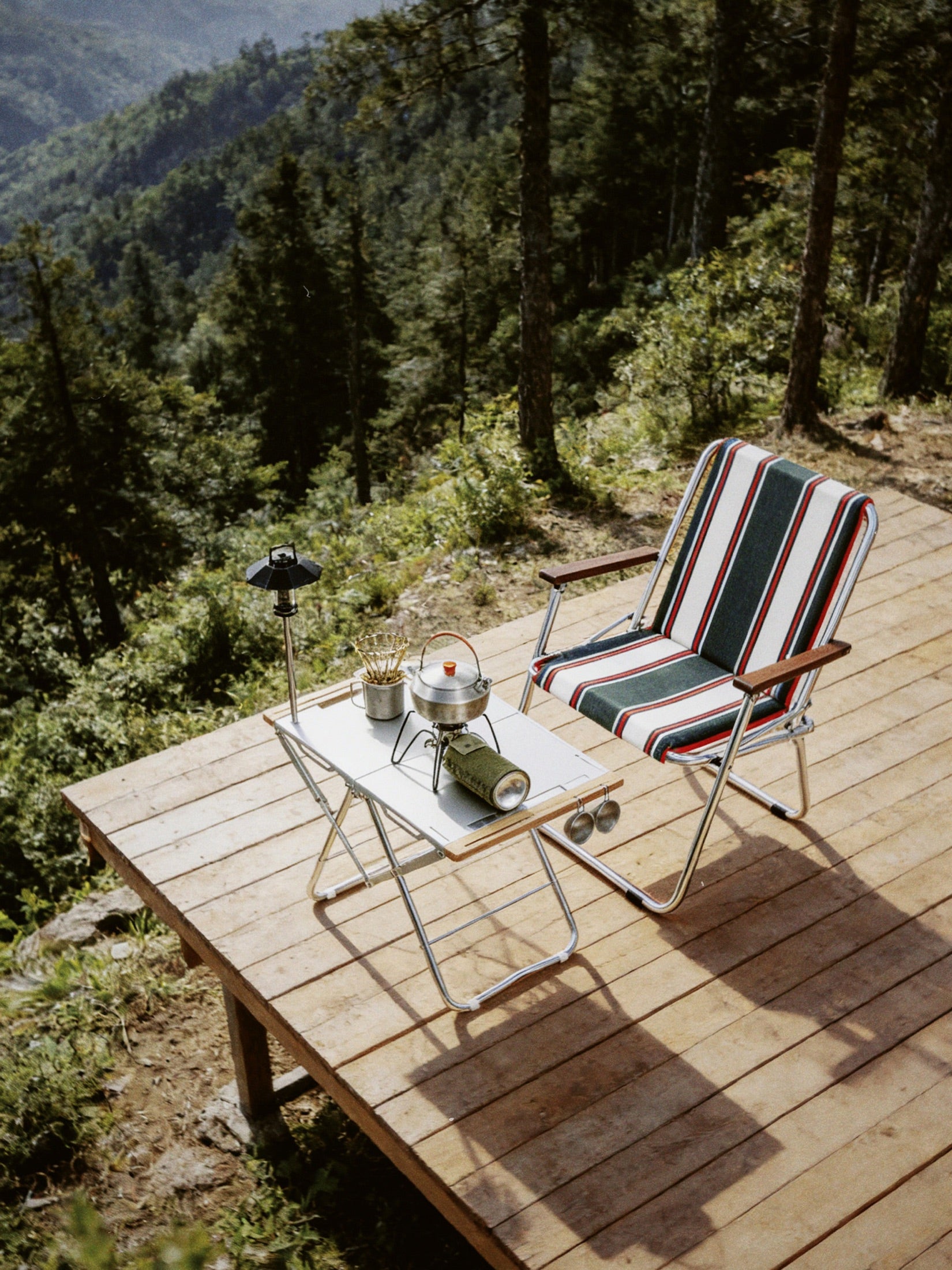 Onway Sports folding chair and table on a mountain deck overlooking a forest valley