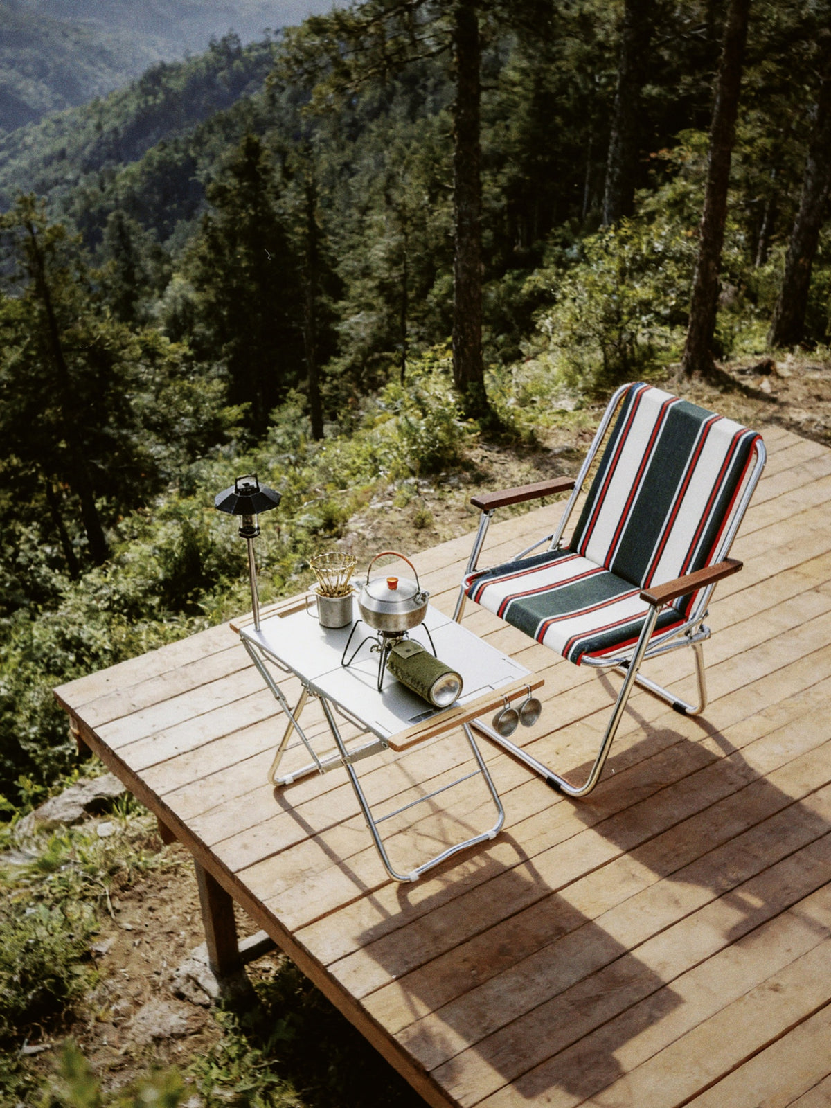 Onway Sports folding chair and table on a mountain deck overlooking a forest valley
