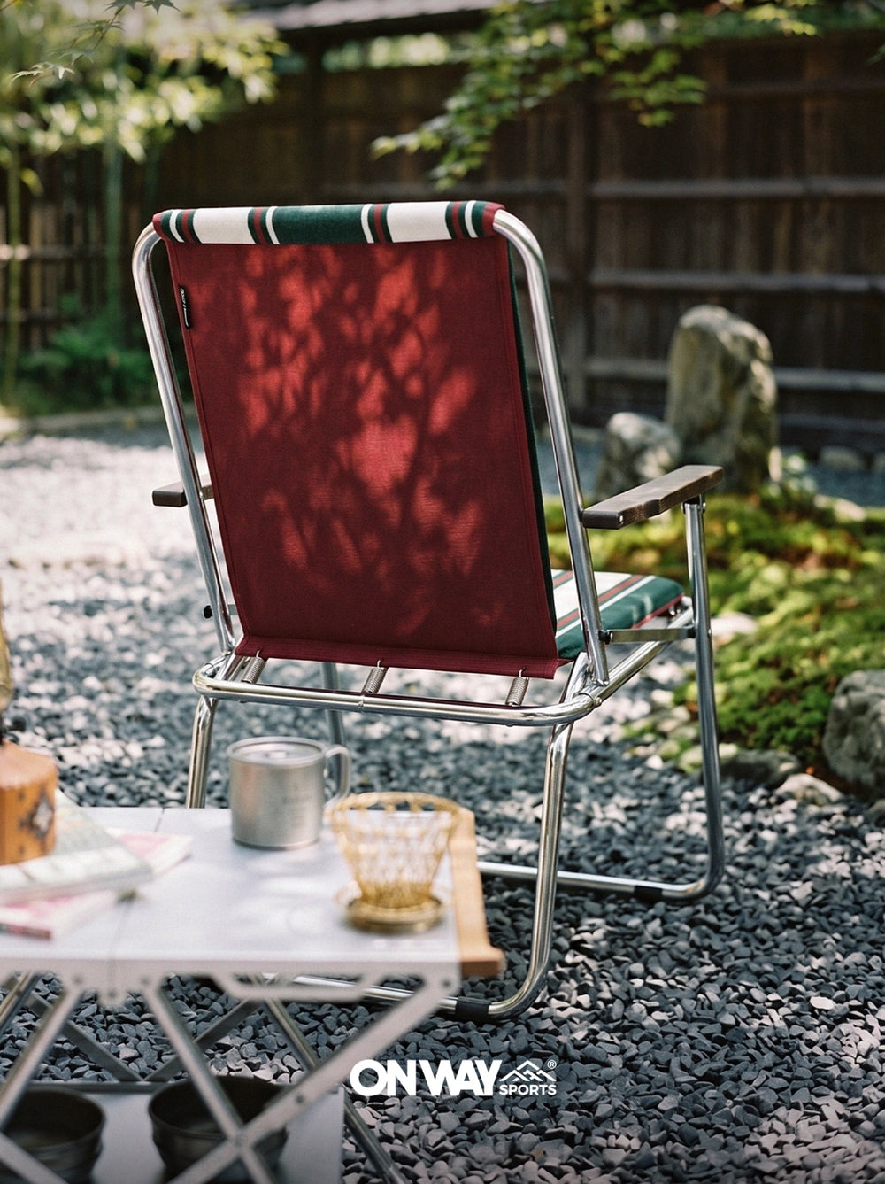 Onway Sports folding lounge chair with striped fabric in a Japanese garden